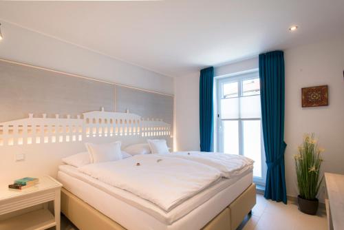 A bed or beds in a room at Chiemsee Suiten