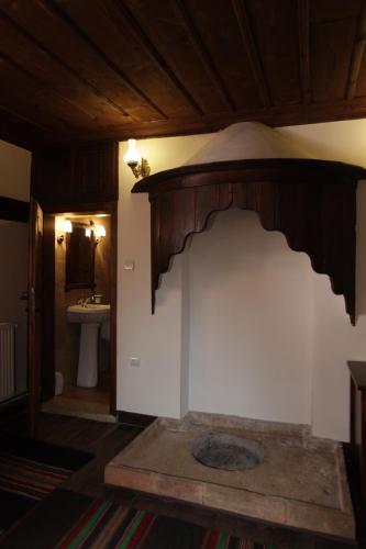 a room with a bathroom with a sink and a room with at Djudjeva Kyshta Hotel in Panagyurishte