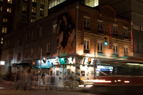 a city street at night with tall buildings at The Rex Hotel Jazz & Blues Bar in Toronto