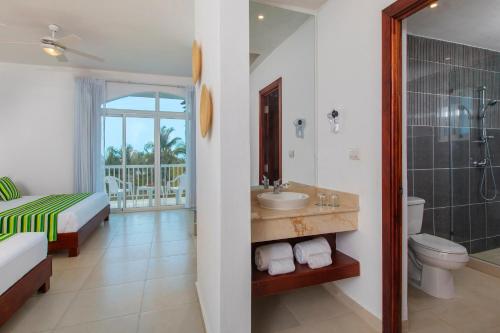 a bathroom with a sink and a toilet and a shower at whala!bayahibe - All Inclusive in Bayahibe