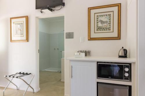 a kitchen with a counter and a microwave in it at Lemoenfontein in Beaufort West