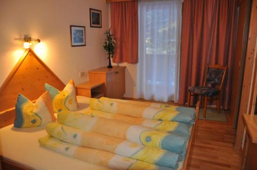 a bedroom with a bed with pillows on it at Alpenspirit in Sölden