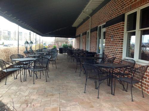 a group of tables and chairs on a patio at Days Inn by Wyndham Hershey in Hershey