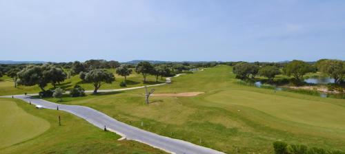 an aerial view of a golf course with a winding road at Fairplay Golf & Spa Resort in Benalup Casas Viejas
