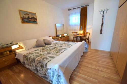 a bedroom with a large bed in a room at Apartments Celebrini in Malinska