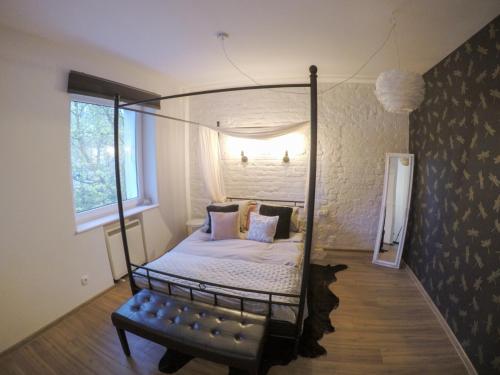 a bedroom with a four poster bed and a window at Apartament Ważka in Gdynia