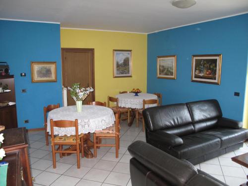 a living room with a couch and a table and chairs at Residence Le Azalee & SPA in Vercana