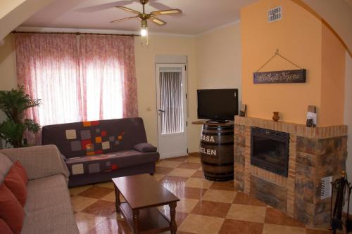 a living room with a couch and a fireplace at Casa Rural Maria Belen in Ruidera