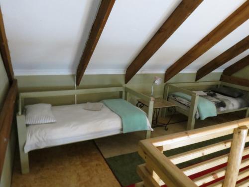 a small room with a bed and a desk at TNiqua Stable Inn in Plettenberg Bay