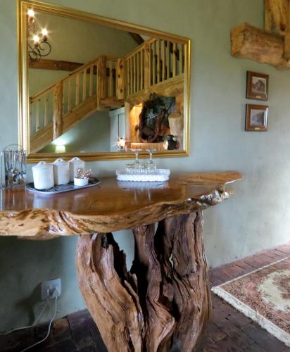 a table made out of a tree stump at TNiqua Stable Inn in Plettenberg Bay