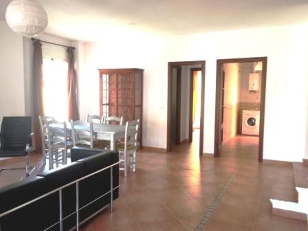 a dining room with a table and chairs in a building at Vivienda Rural in Olivares