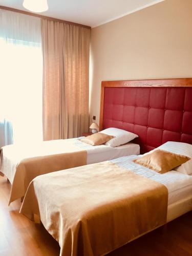a hotel room with two beds and a window at Neptun in Międzychód