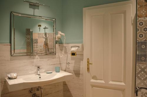a bathroom with a sink and a mirror at Hotel Settentrionale Esplanade in Montecatini Terme