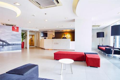 a lobby with red and blue furniture and a counter at Red Planet Cebu in Cebu City