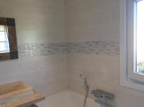 a bathroom with a bath tub with a faucet at Maison du golf in Nieuwpoort