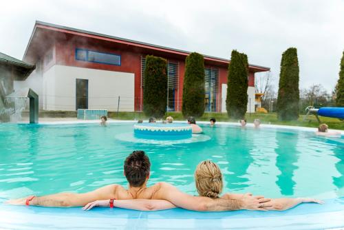 a group of people sitting in a swimming pool at Thermal Hotel Balance Lenti in Lenti