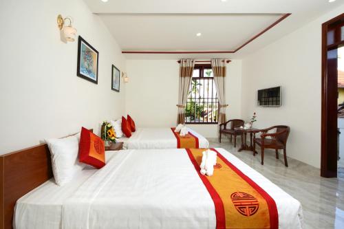 Postel nebo postele na pokoji v ubytování Hoi An Dat Cam Homestay