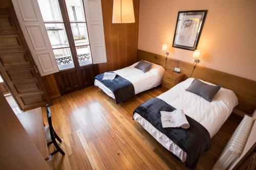 Postel nebo postele na pokoji v ubytování La Posada de La Casona de Sarria