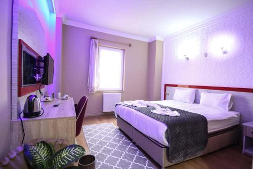 a bedroom with a bed and a desk in a room at Casablanca Garden Hotel in Nevşehir
