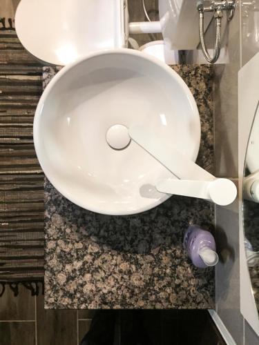 a bathroom with a white sink on a counter at Guest house Nizama's Place in Sarajevo