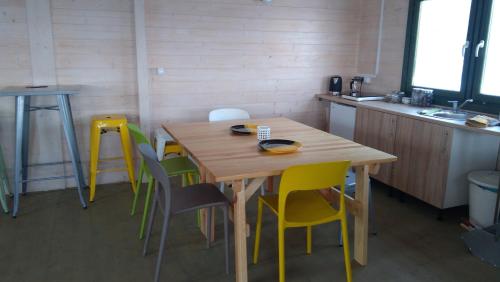 a kitchen with a wooden table and chairs at Widokowa Osada in Międzylesie