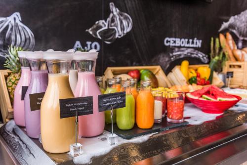 a display of different colored bottles of juice and fruit at ibis Barranquilla in Barranquilla