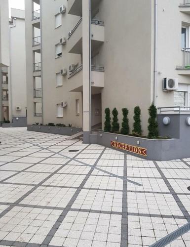 a building with a sign on the side of it at Holiday Wing Apartments in Jagodina