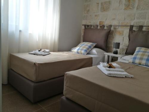 Postel nebo postele na pokoji v ubytování Hotel Residence La Corvetta