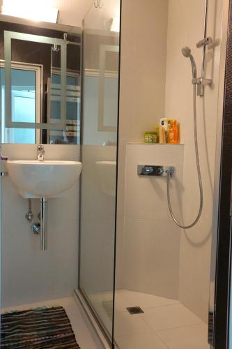 a bathroom with a shower and a sink at Silver Beach Delux Apartment in Byala