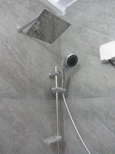 a shower in a bathroom with a shower head at Twin Villa 22 in Katugastota