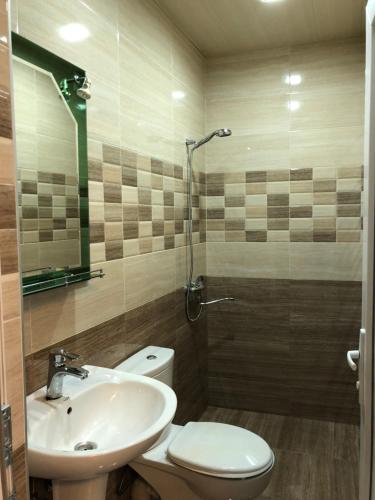 a bathroom with a sink and a toilet at Kutaisi Grand Suites in Kutaisi