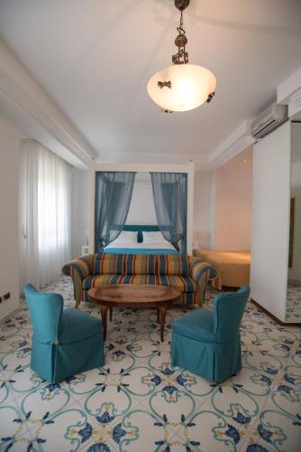 a living room with a couch and two chairs at Hotel Villa Maria in Sorrento