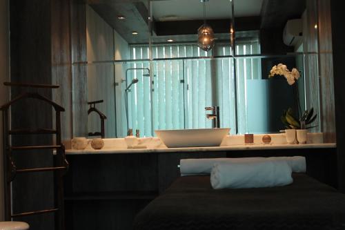 a bathroom with a sink and a bath tub at Tskaltubo Hotel Prometheus in Tskaltubo