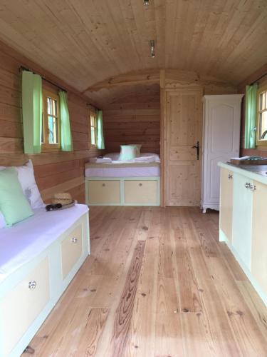 a large room with wooden flooring in a log cabin at Coutillard in Parisot-Tarn-et-Garonne