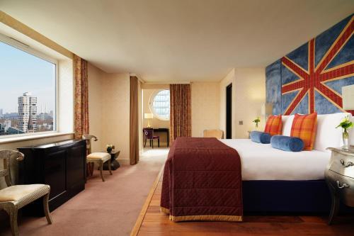 a hotel room with a bed and a large window at The Chelsea Harbour Hotel and Spa in London