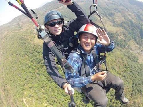 two people on a zip line on a mountain at Everest Home Stay Apartment in Pātan