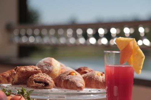 a plate of pastries on a table with a drink at Hotel Miramonti in Bagno di Romagna