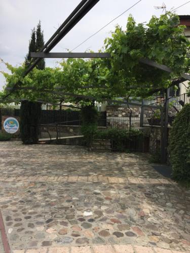 a pergola over a stone patio at Borgo Piccolo in Cavaion Veronese