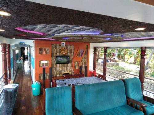 a dining car of a train with blue seats at Vaishnav Tours in Alleppey