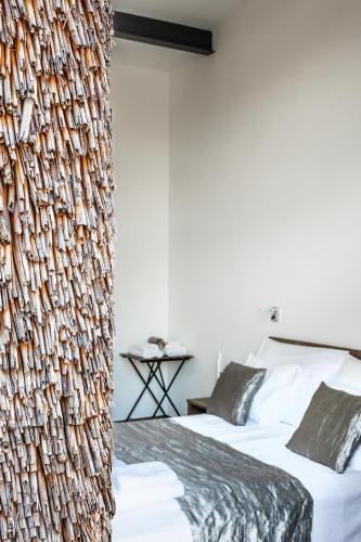 a bedroom with two beds and a wall covered in fishnets at Artkazal in Mórahalom