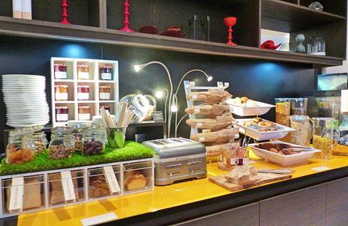 a buffet line with food on display in a restaurant at Novotel Toulouse Centre Compans Caffarelli in Toulouse