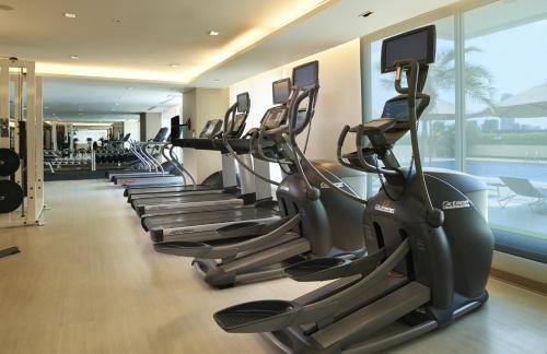 a row of treadmills in a gym with a row of exercise bikes at Shama Lakeview Asoke Bangkok in Bangkok