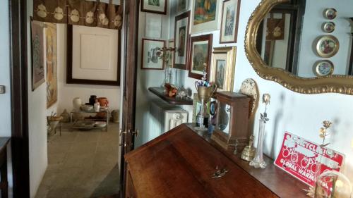 a room with a mirror and a wooden table at Porta Rose in Garessio