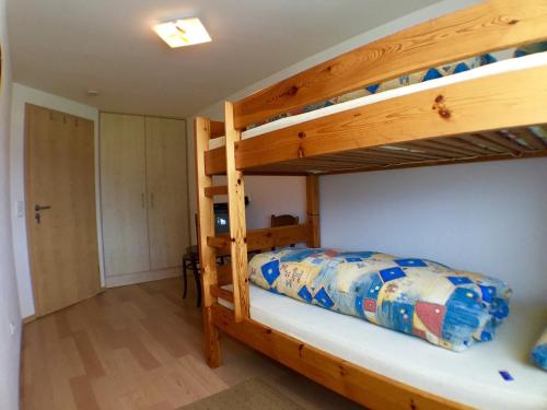 a bedroom with two bunk beds in a house at Ferienhof Prinz in Oberreute