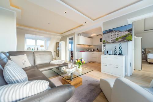 a living room with a couch and a table at Villa Allegra in Binz