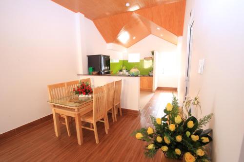 a kitchen and dining room with a table and chairs at Moc Tra Hotel in Da Lat