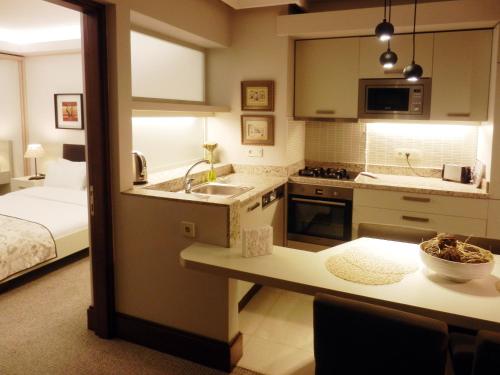 a kitchen with a sink and a bed in a room at 116 Residence in Istanbul