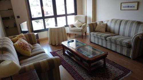 a living room with couches and a coffee table at Norte Sueve in Colunga