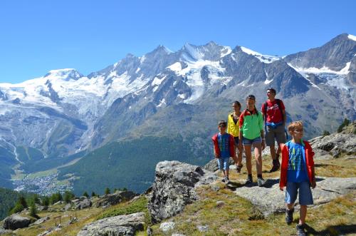 a group of people standing on top of a mountain at Hotel Olympia in Saas-Almagell