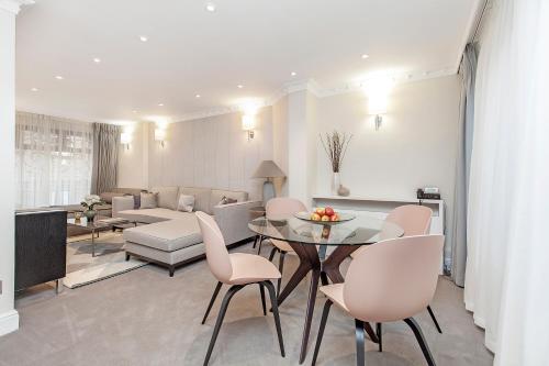 a living room with a table and chairs and a couch at Mayfair House in London